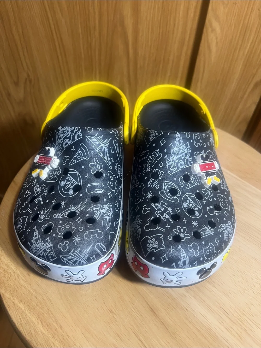 CROCS Kids Black Clogs with Yellow Heel Straps and White Doodle Prints